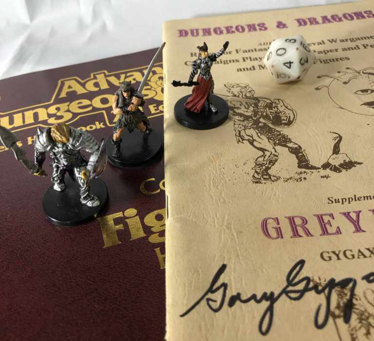 Миниатюры паладина, клерика и варвара на книгах D&D